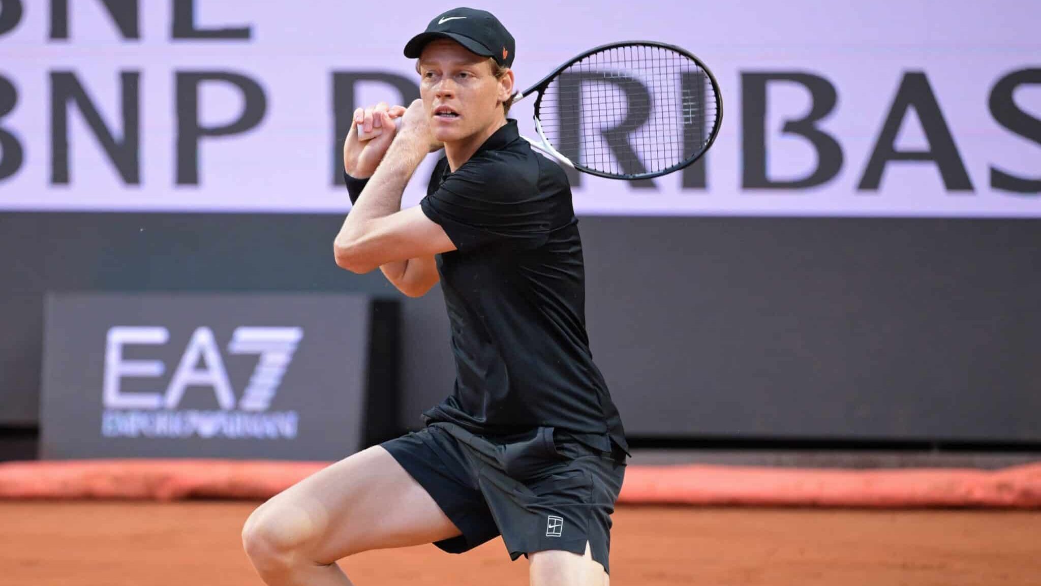 Jannik Sinner segura a raquete de tênis com as duas mãos