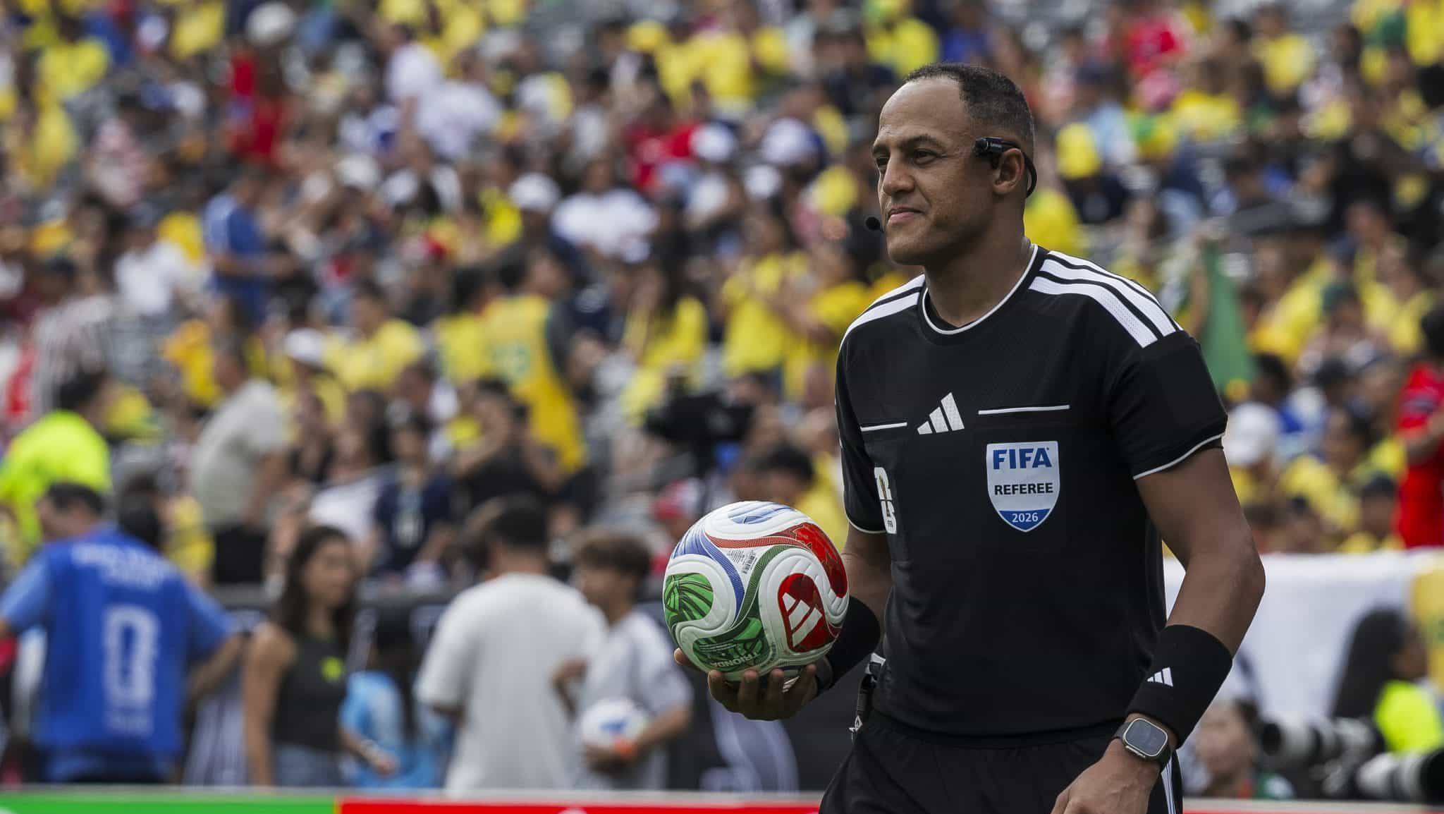 The referee Ismail Elfath holds the ball during the FIFA